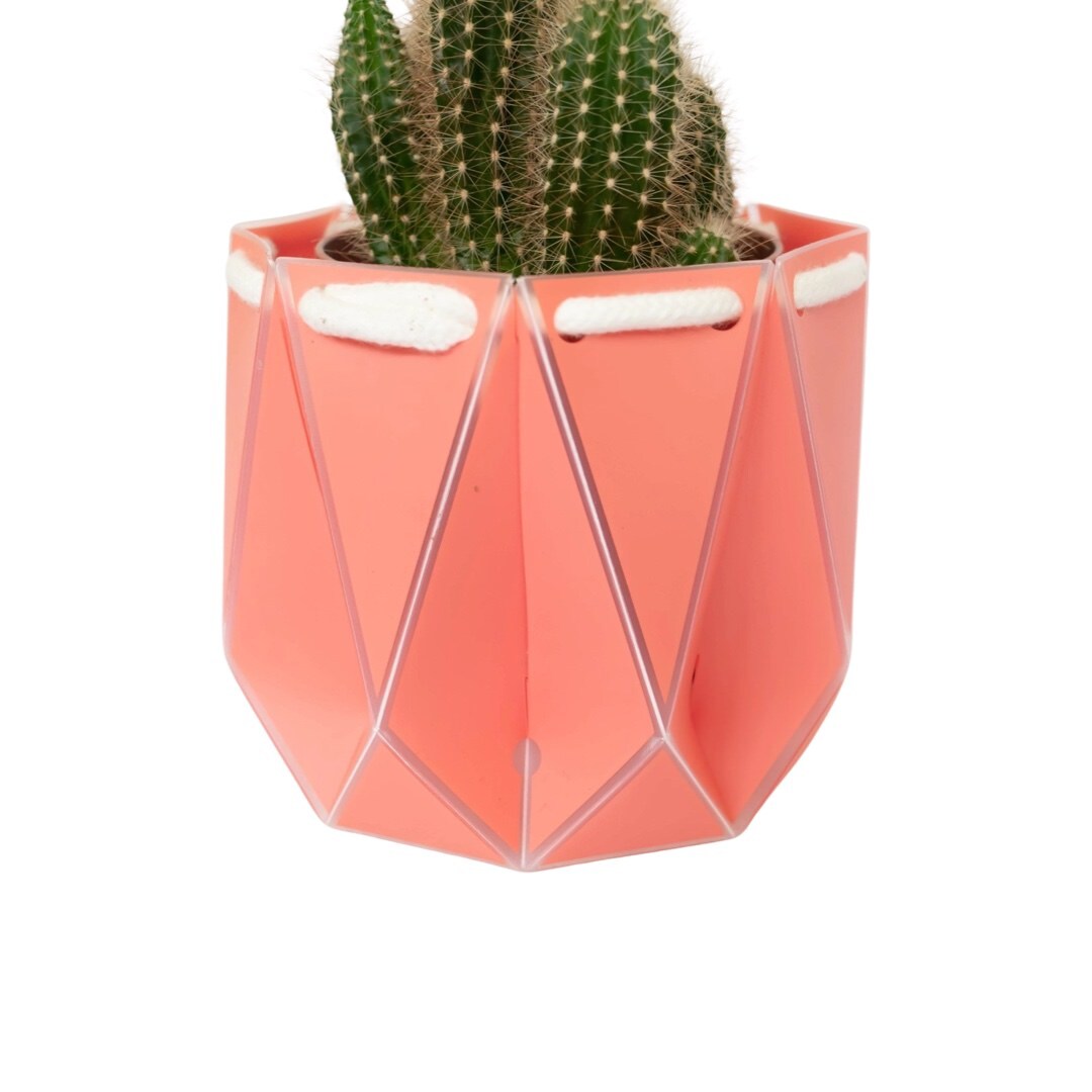 A coral coloured recycled plastic plant pot.