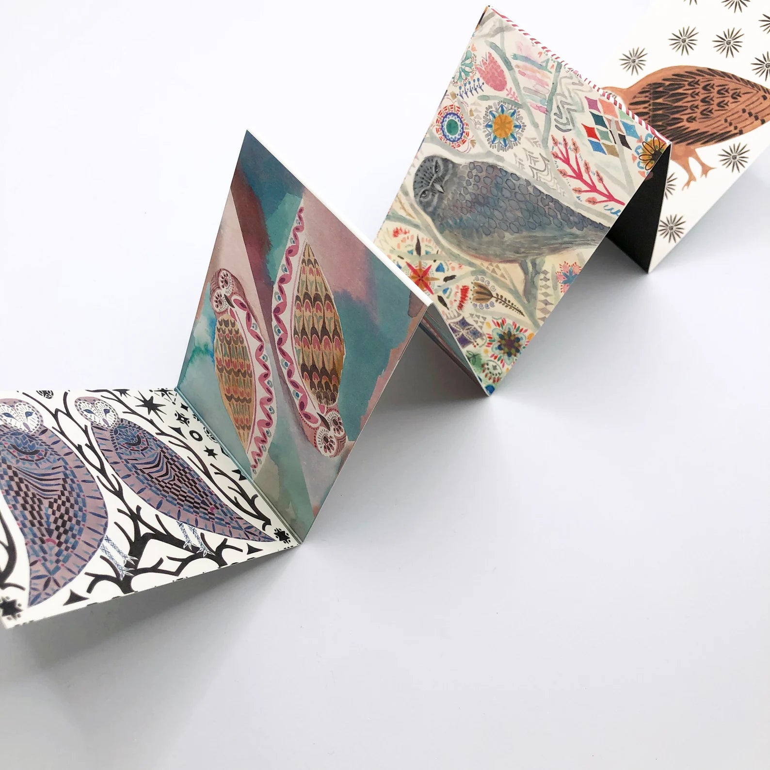 Colourful folded card on a white background.