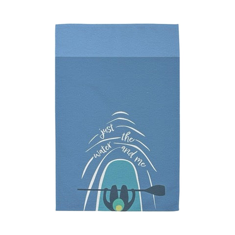 Tea towel featuring a paddle boarder out in the sea on their board and the text "just the water and me".