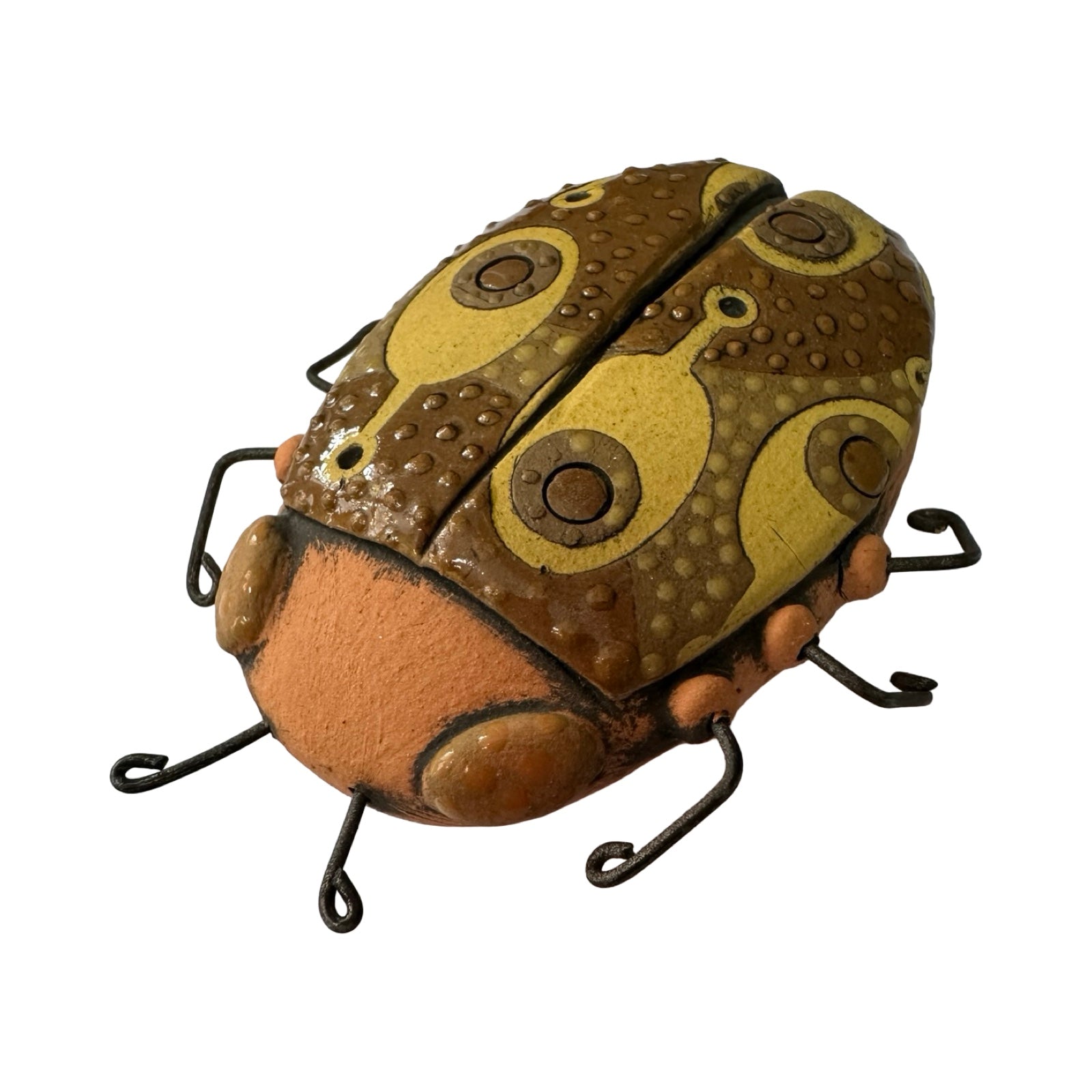 Ceramic beetle decorated in brown with a yellow paddle-shaped pattern.