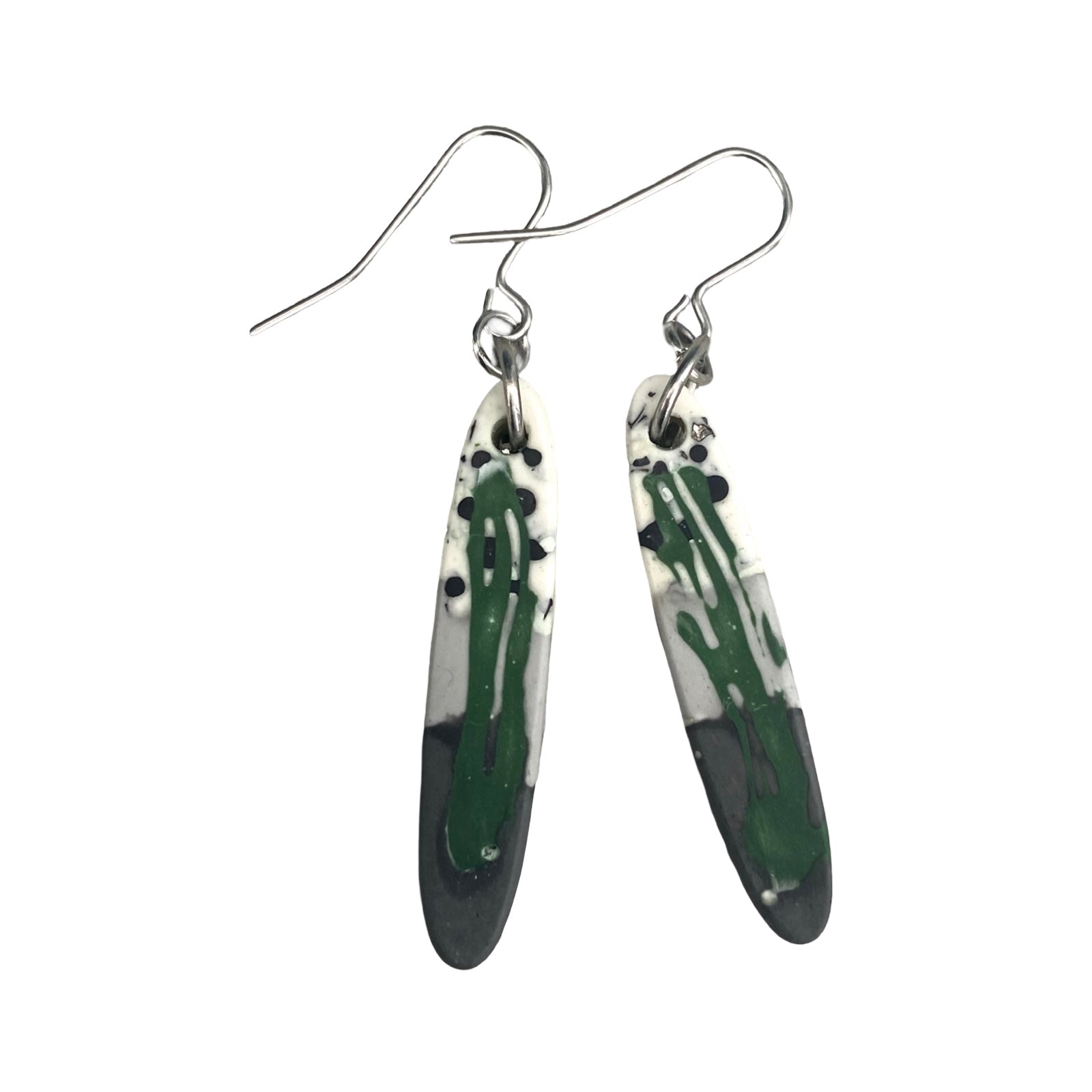 Long thin oval shaped earrings in a green, grey, back and white paint design with silver ear hooks.