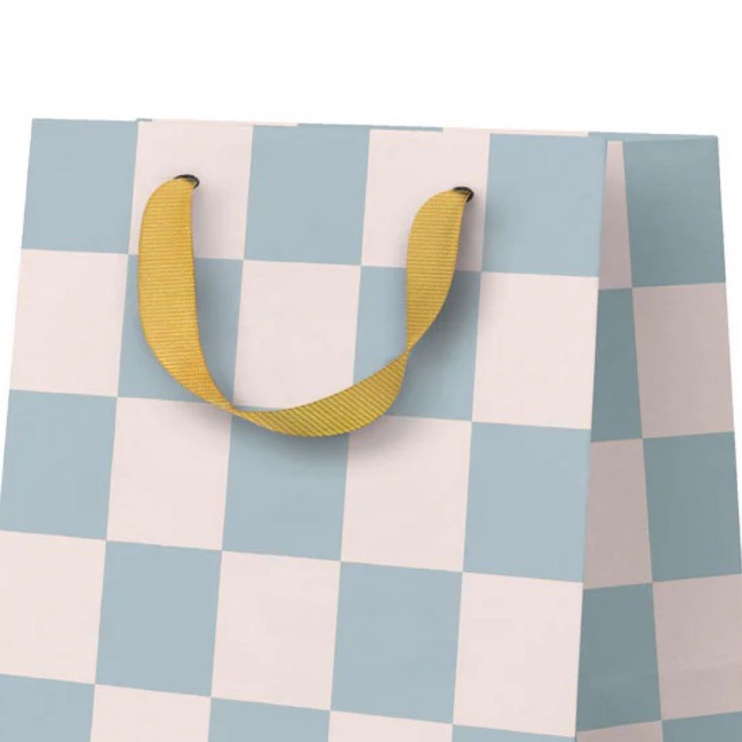 Checkered gift bag with yellow handles on a white background.