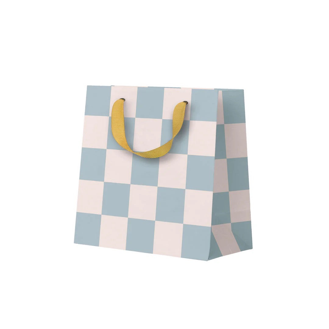 Checkered gift bag with yellow handles on a white background.