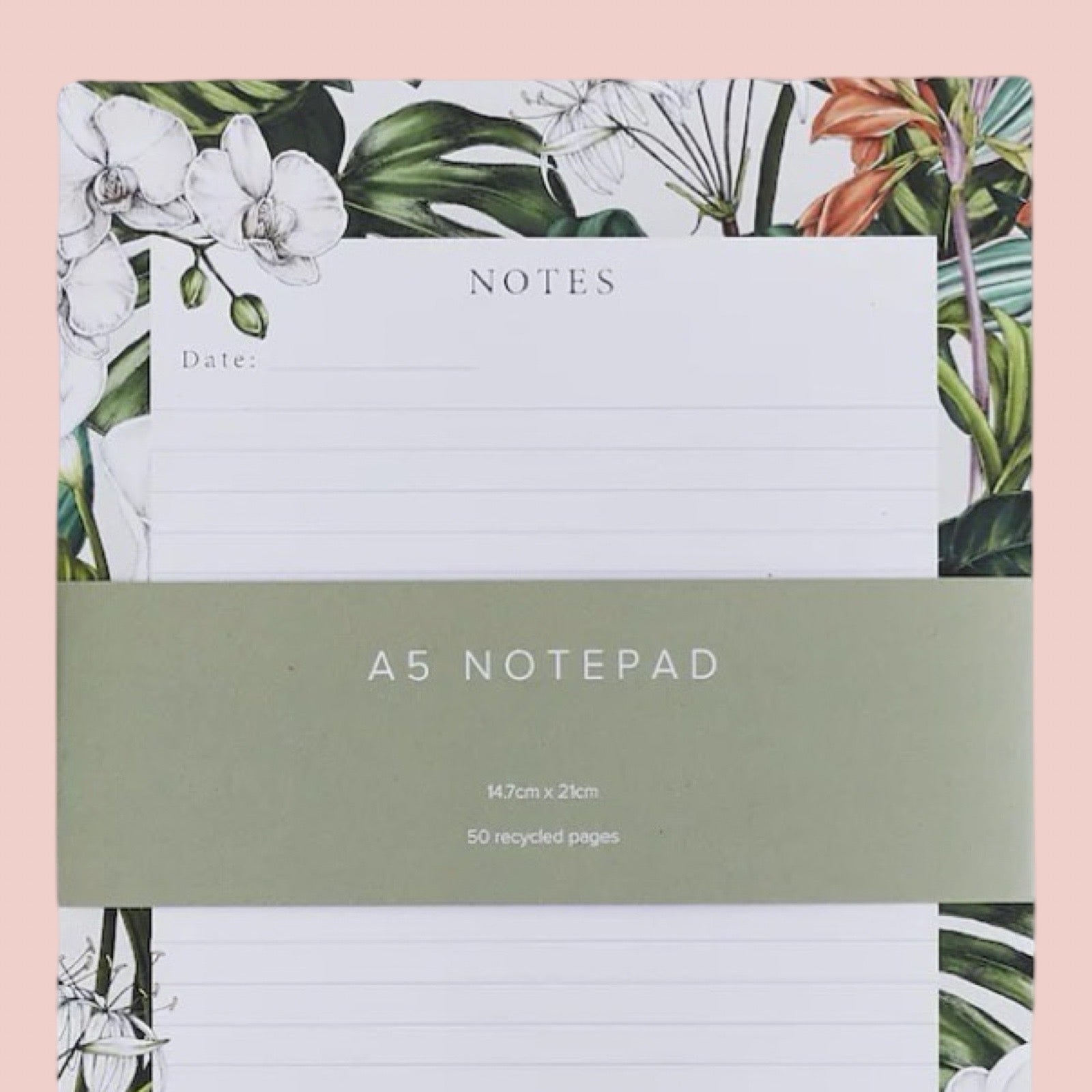 A5 notepad with floral design on the cover against a pink background.