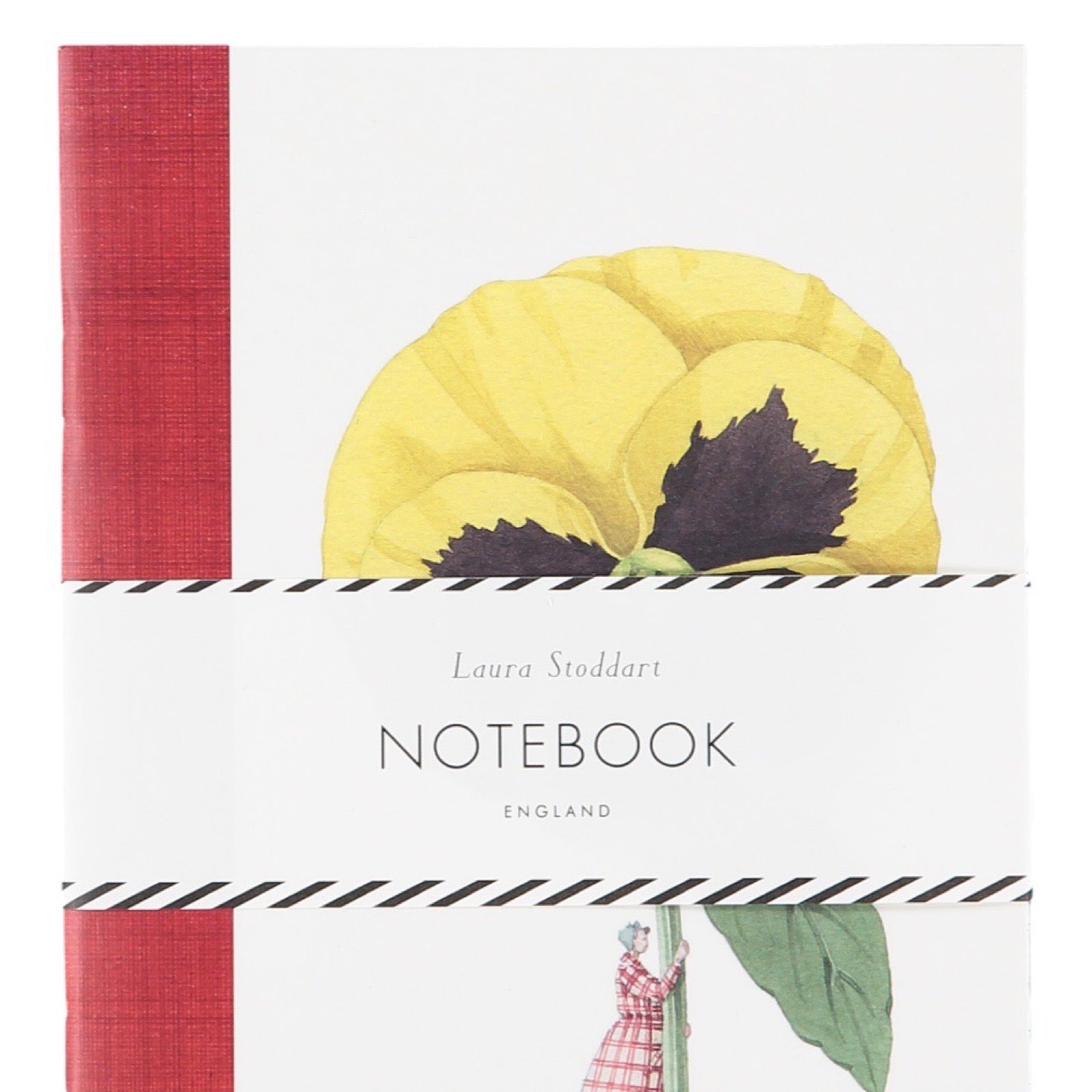 Notebook with a red cover and yellow floral design on a white background.