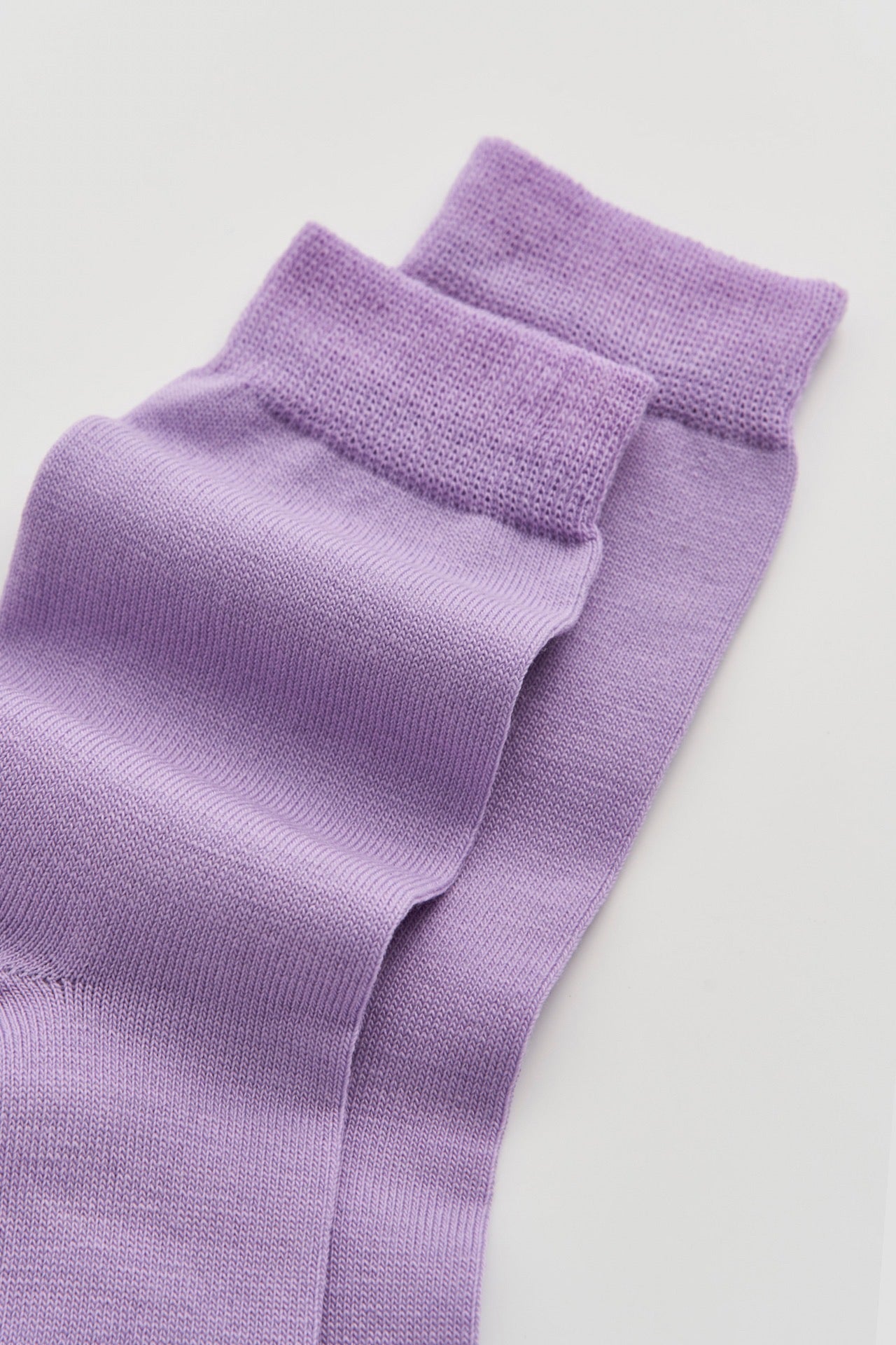 Pair of parma violet socks on a light background.