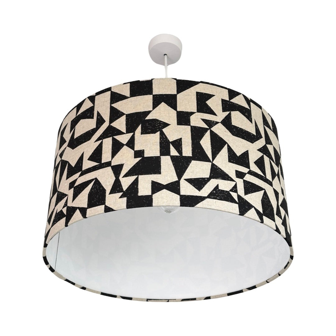 drum lampshade covered in a black and white geometric patch fabric