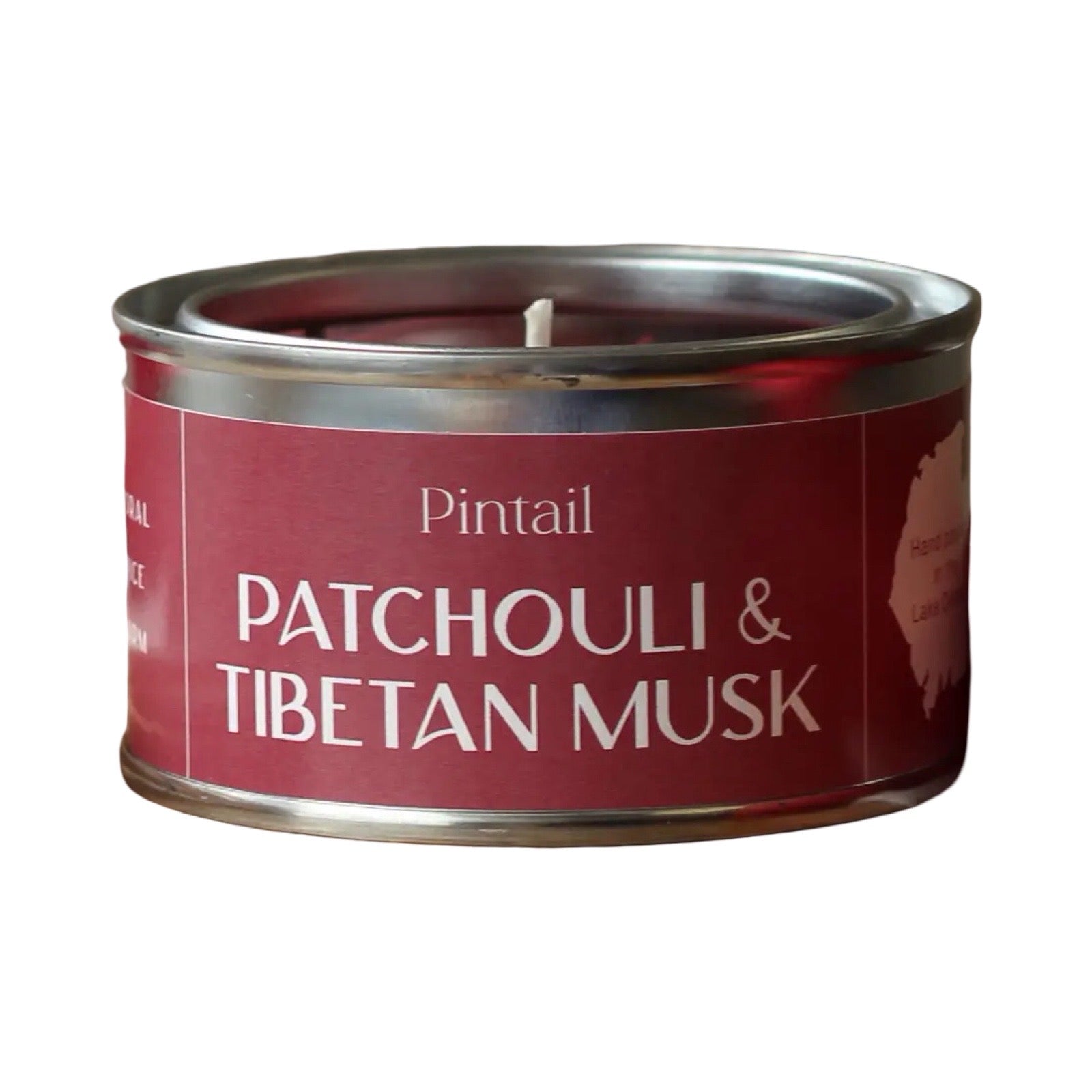Candle in a red tin labeled 'Patchouli & Tibetan Musk' by Pintail on a white background.