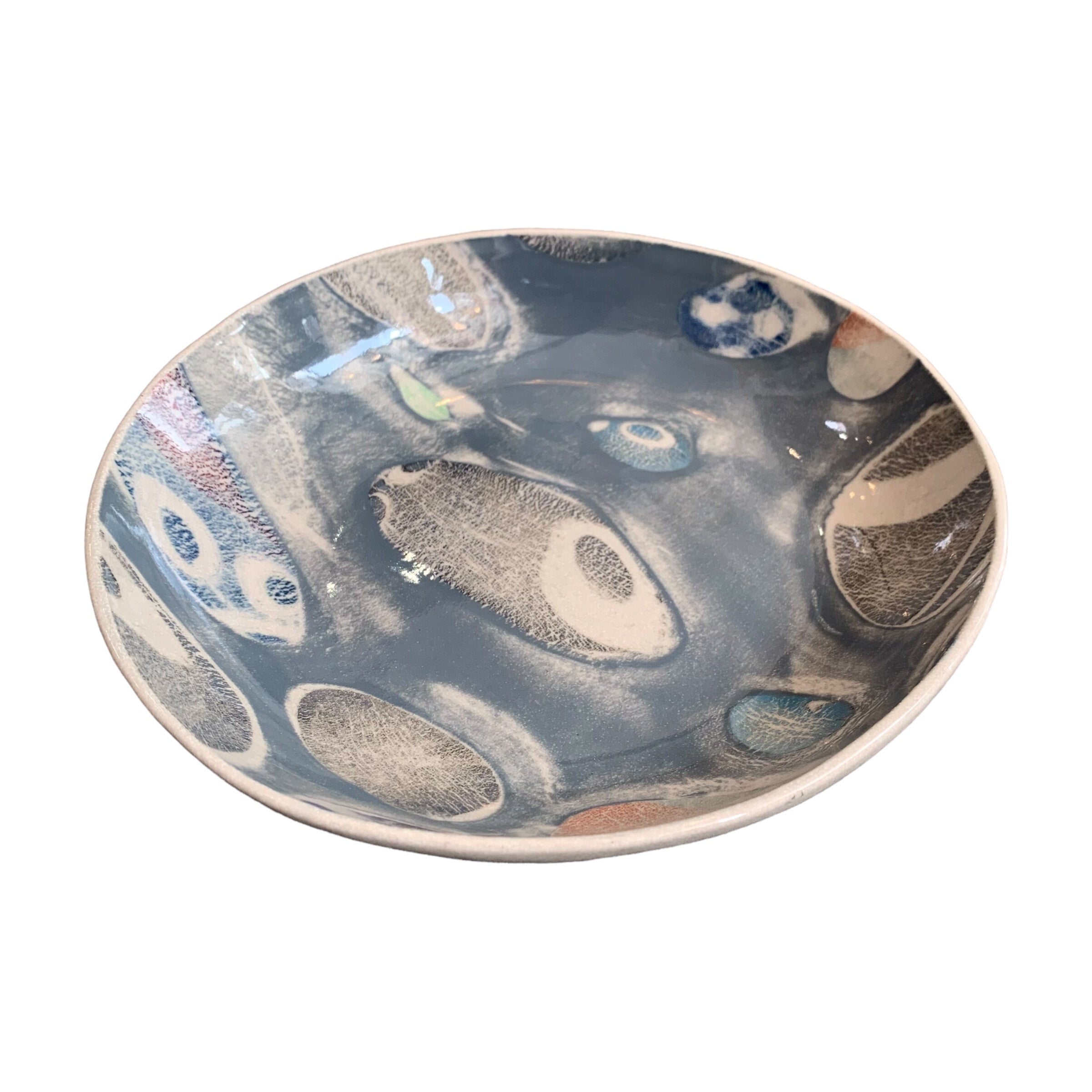 A grey ceramic pasta bowl with a colourful pebbles design.