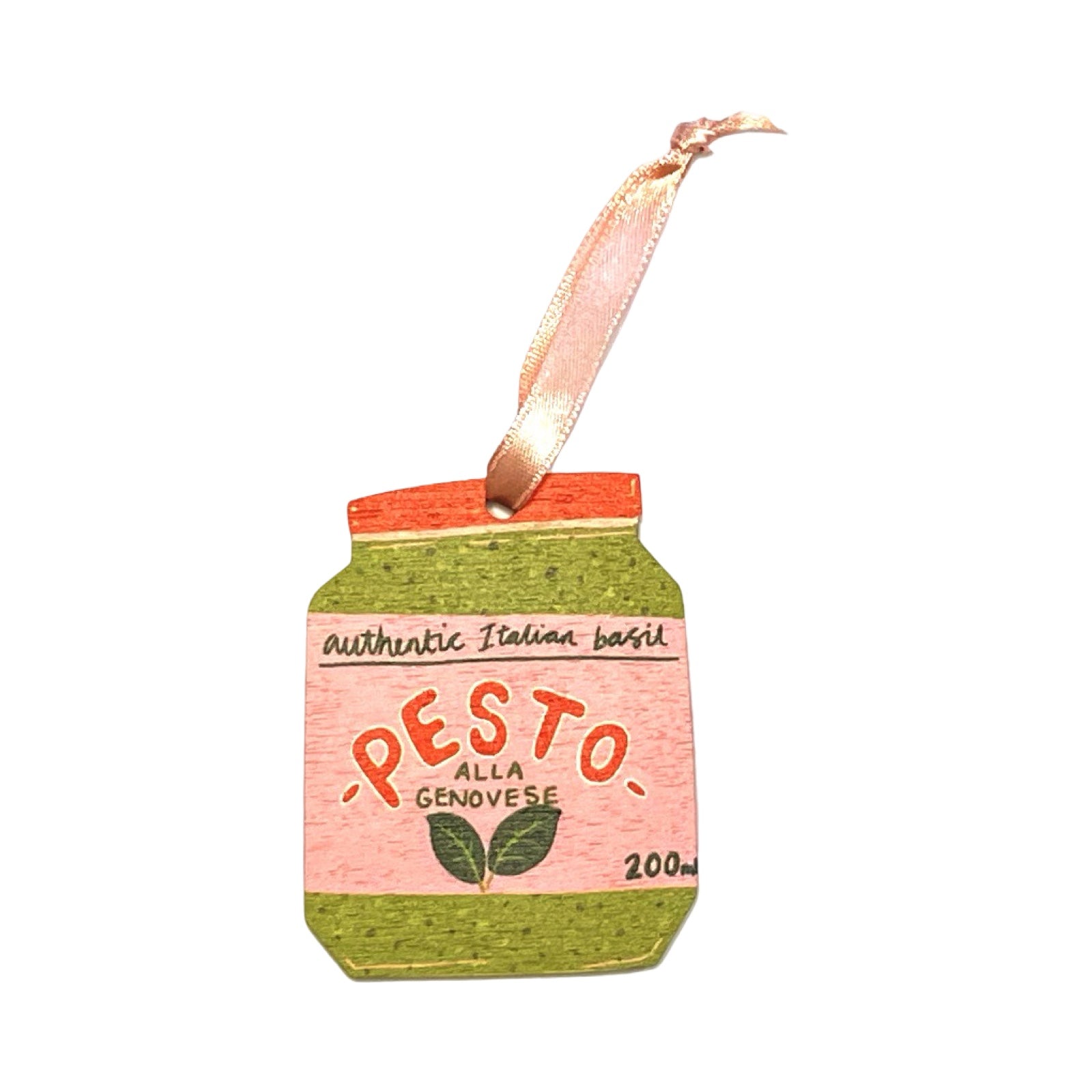 A wooden Christmas decoration of a jar of pesto. 