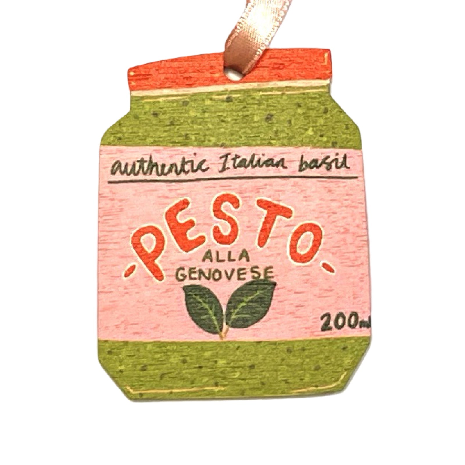 A wooden Christmas decoration of a jar of pesto. 