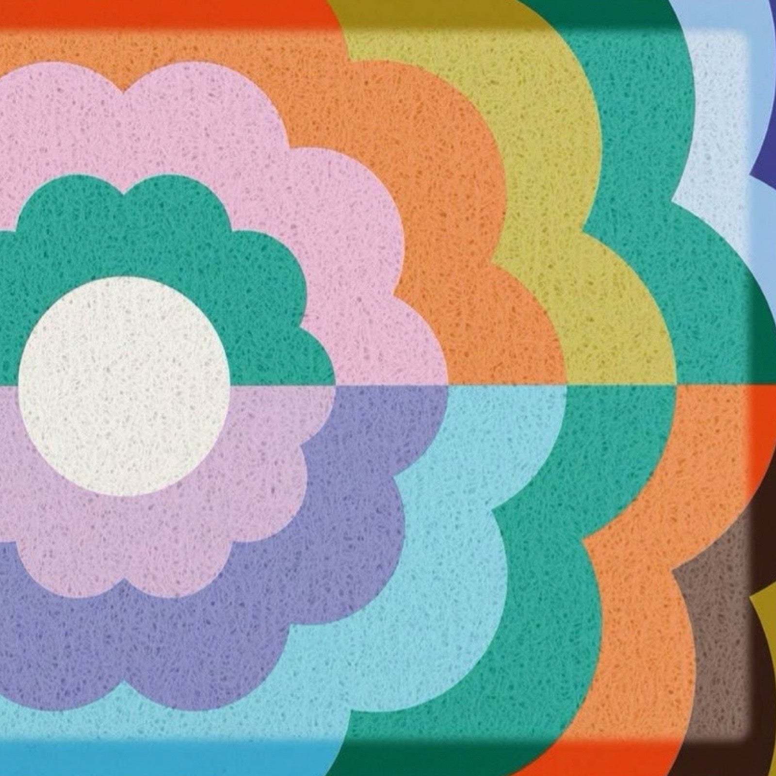 A close-up of a retro 1970s-style floral pattern with concentric scalloped flower shapes in pink, green, purple, blue, orange, yellow, and white, with a speckled texture.