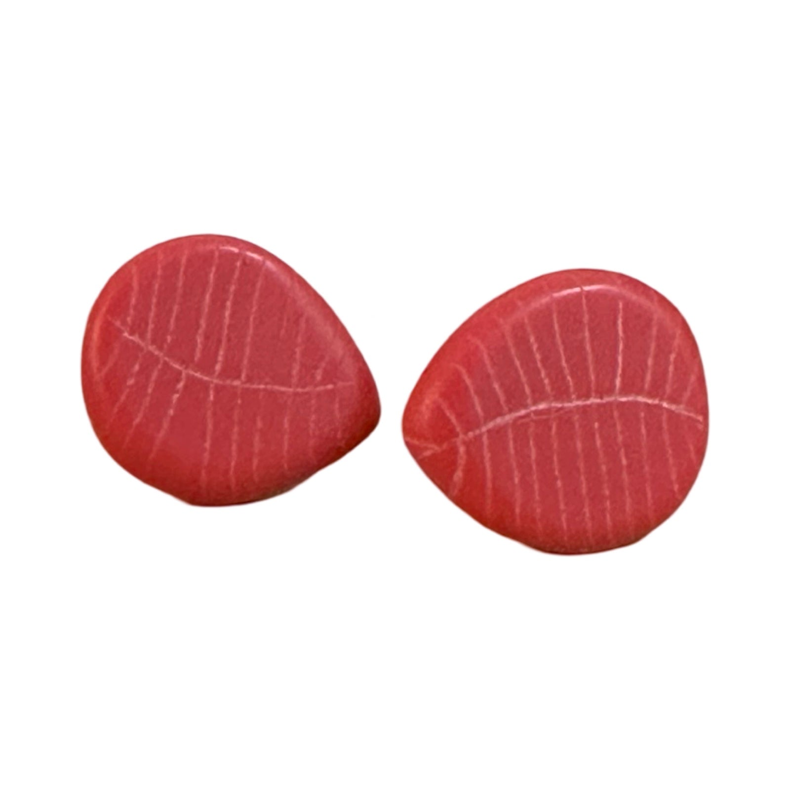 A pair of red petal-shaped earrings with engraved leaf detail.