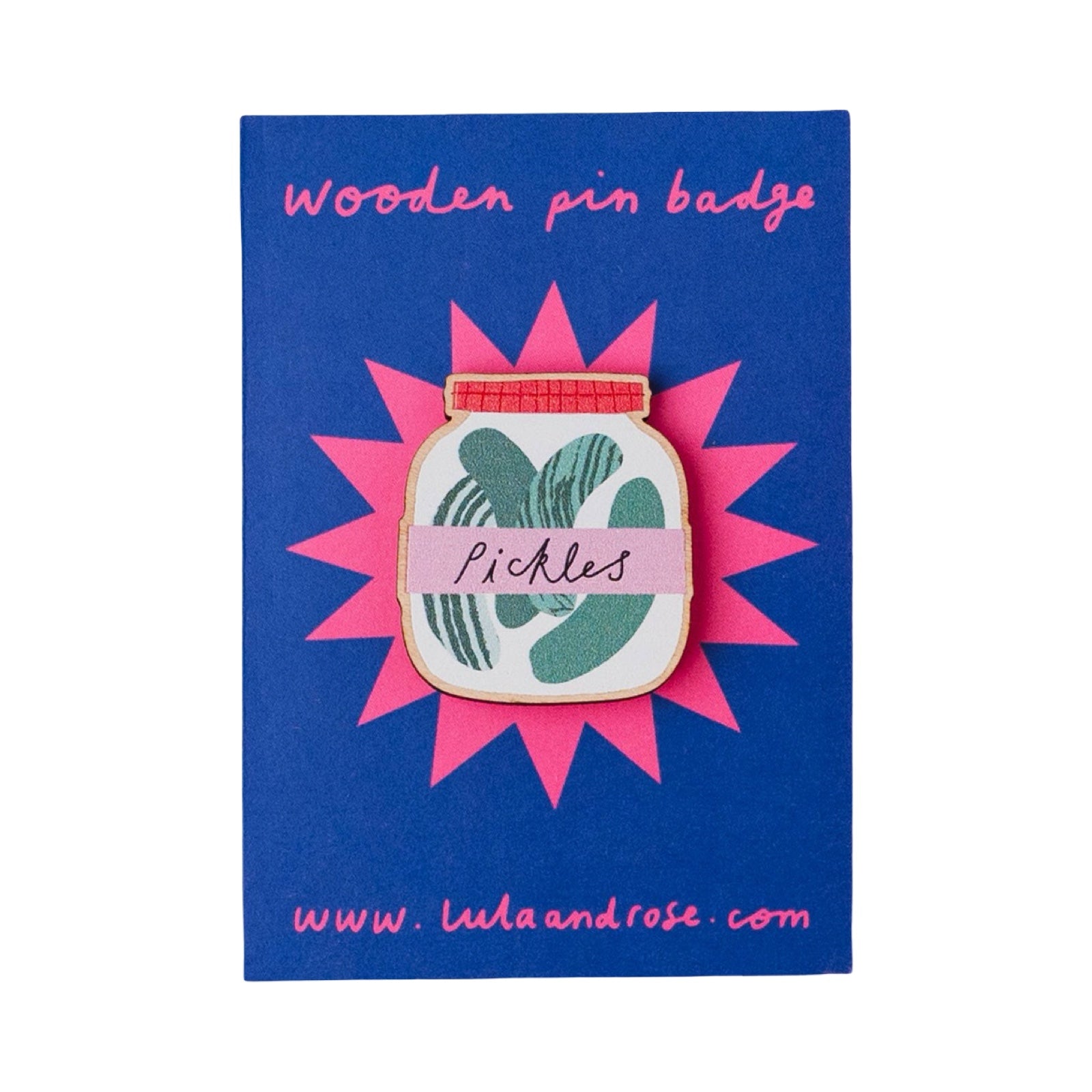A wooden pin badge with a green pickle illustration and a pink banner reading 'Pickles', mounted on a blue backing card with pink text.
