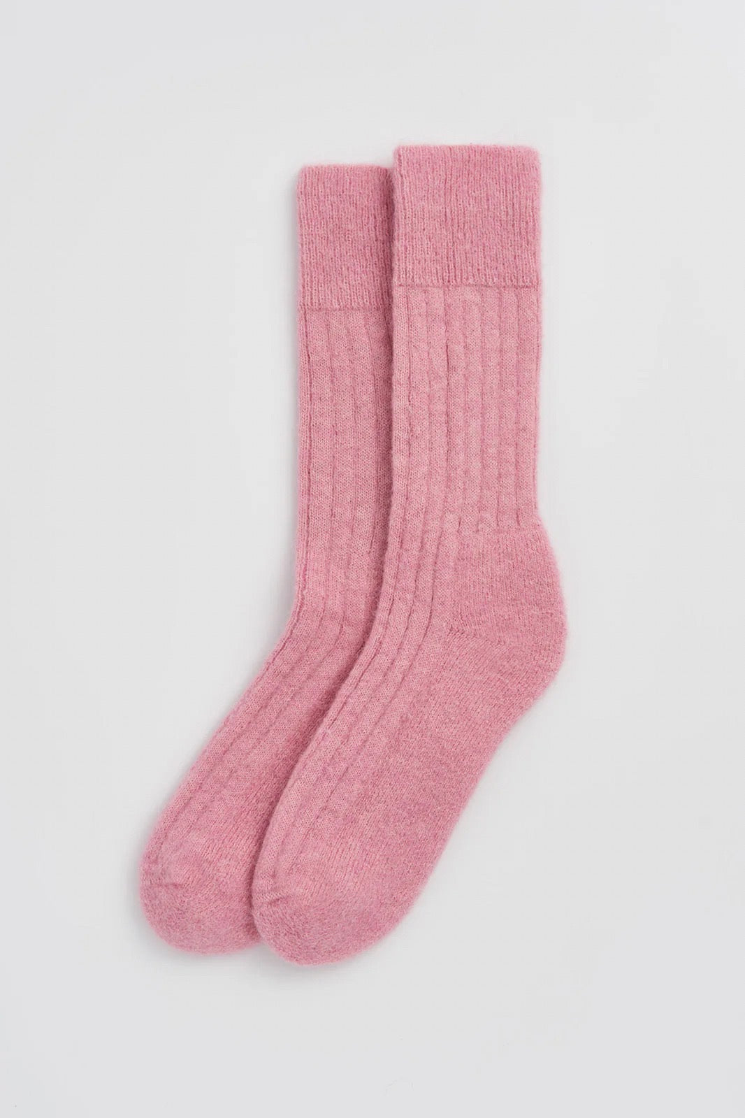 Pair of pink socks on a light background.