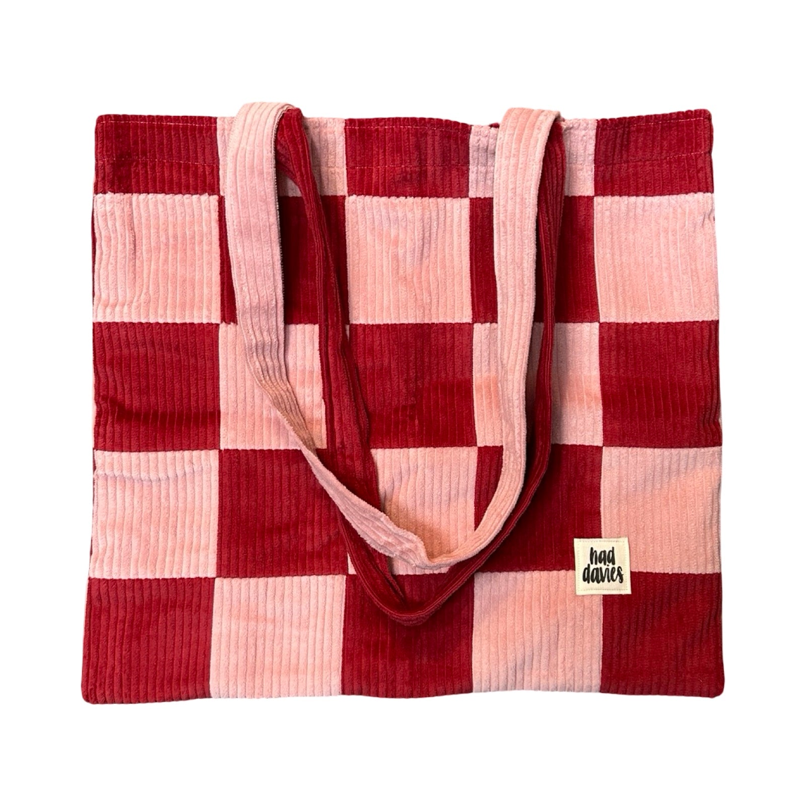 Red and pink checkered tote bag with a visible brand label on a white background.