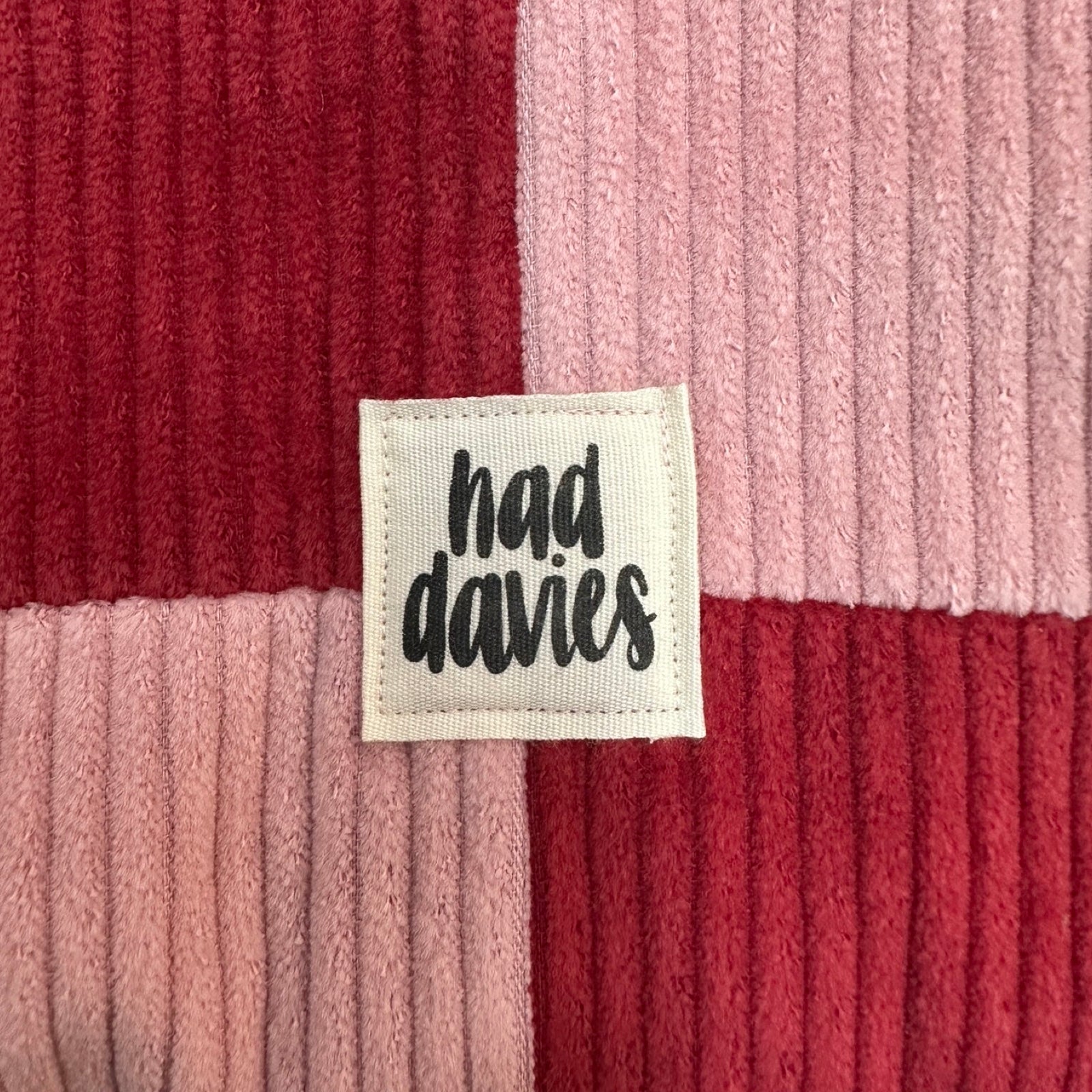 Close-up of a ribbed fabric with a 'had davies' label.