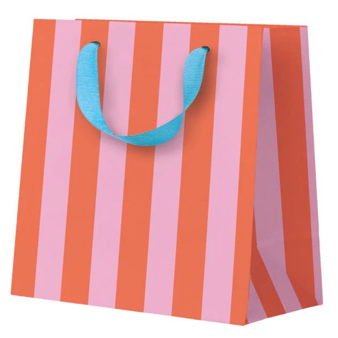 Striped gift bag with orange and pink vertical stripes and a blue handle on a white background.