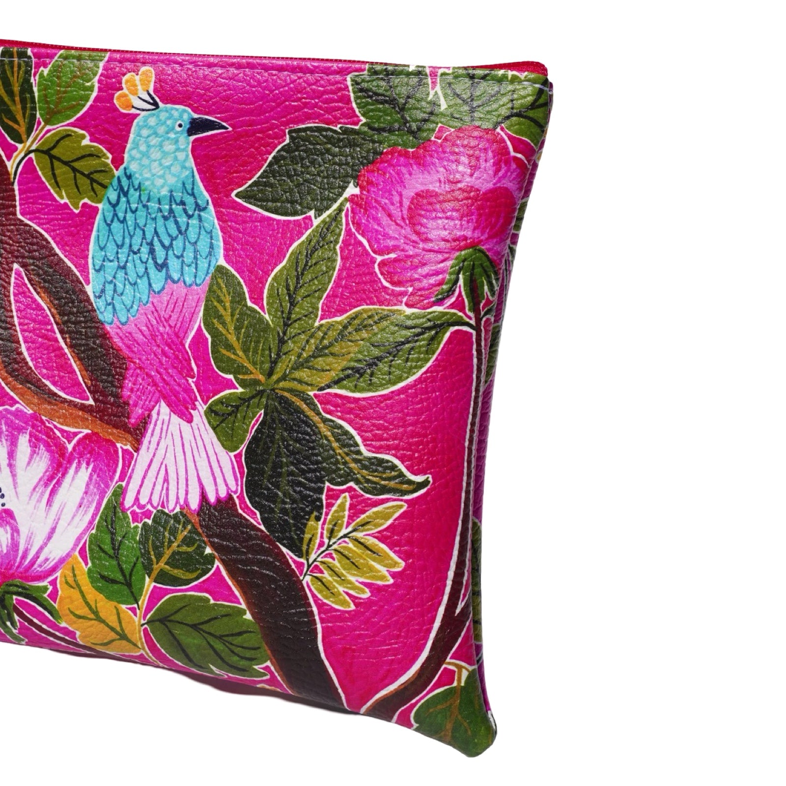 Vegan leather bag with a blue and pink bird perched on a branch surrounded by tropical leaves, and the bag is finished with a fabulous matching tassel on the end of the zip. 