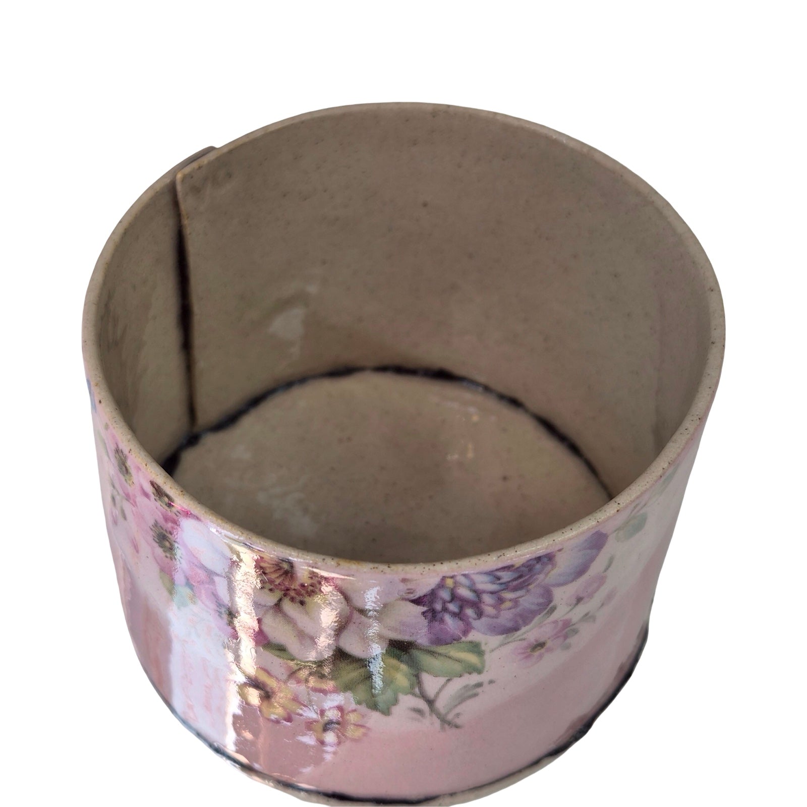Ceramic planter with floral design on a white background.