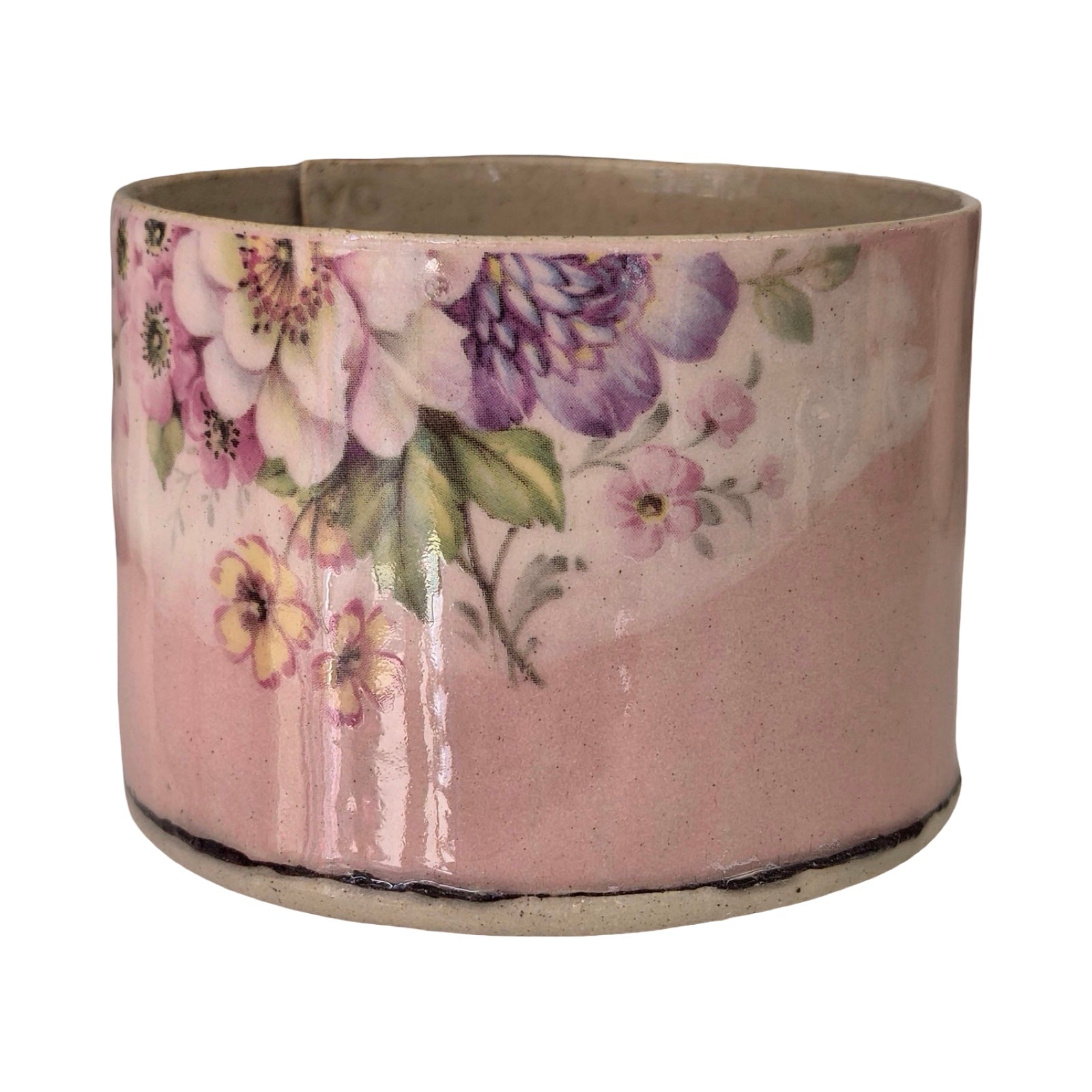 Ceramic planter with floral design on a white background.