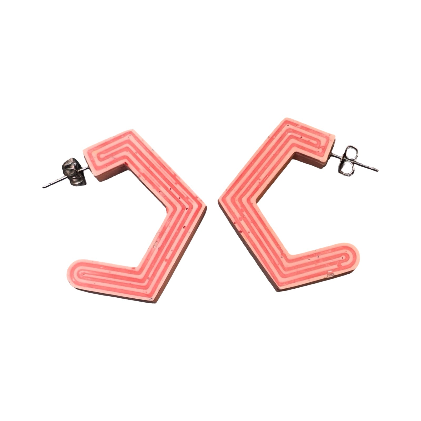 Pink chunky hexagon hoop earrings with red stripes.