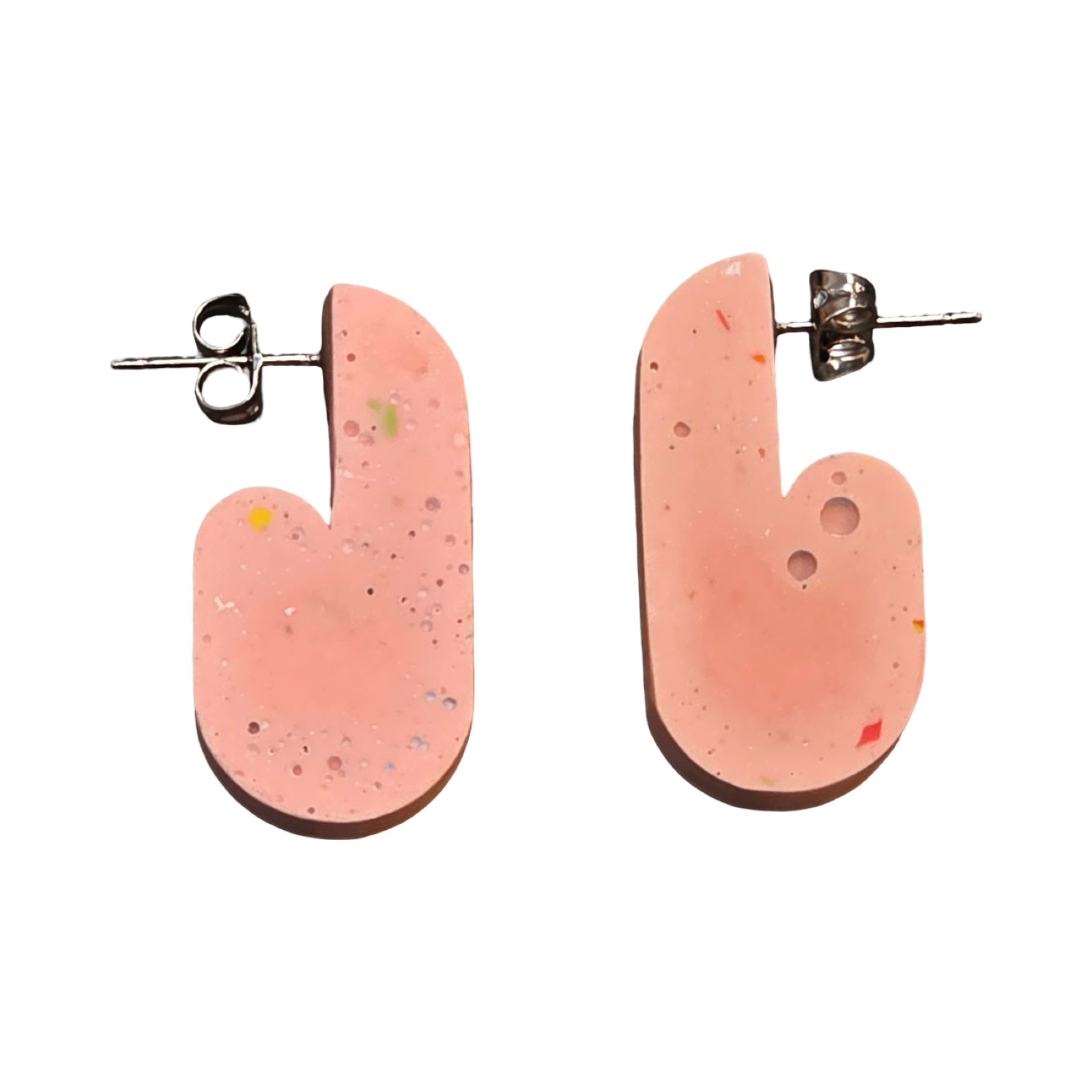 Pink chunky curved hoop earrings with red stripes.