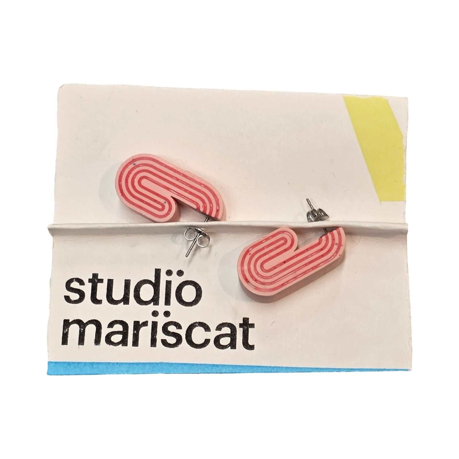 Pink chunky curved hoop earrings with red stripes.