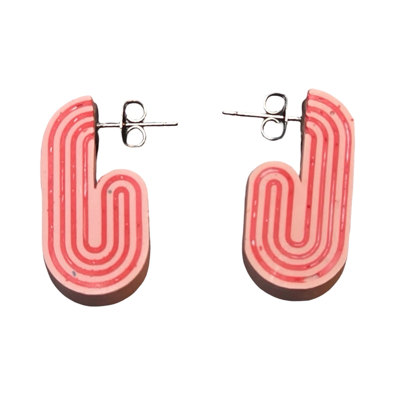 Pink chunky curved hoop earrings with red stripes.
