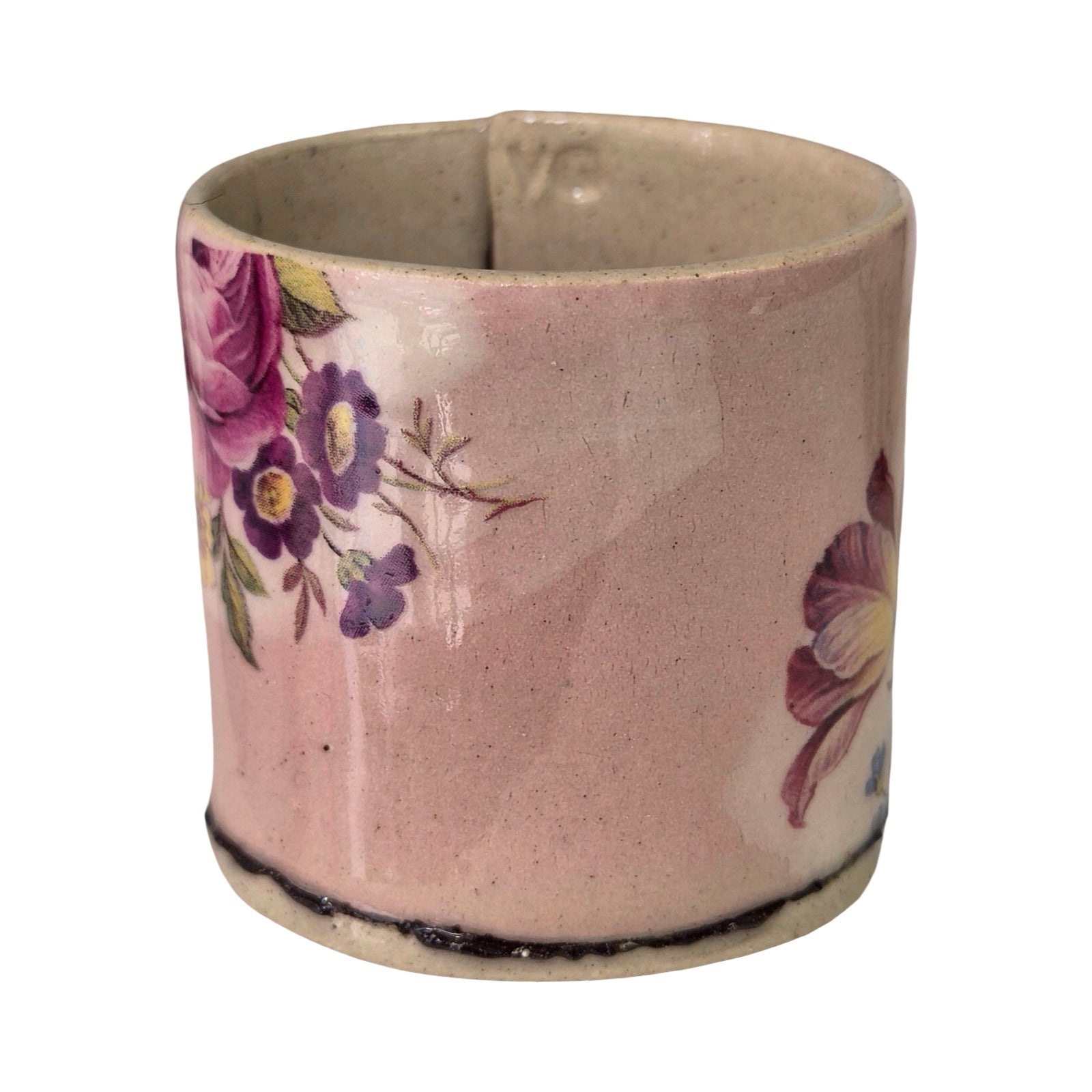 Ceramic mug with floral design on a white background.