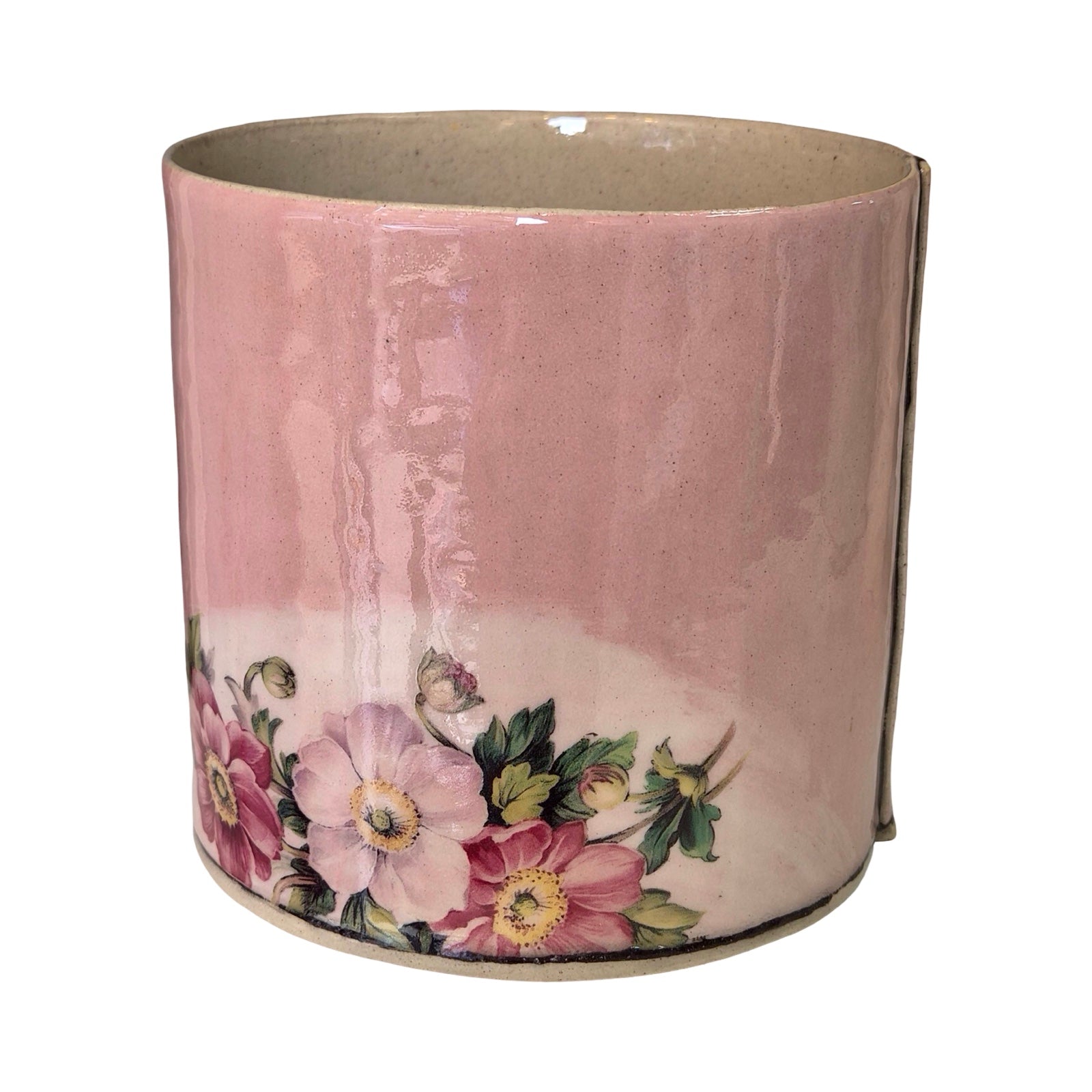 Decorative cylindrical planter with floral design on a white background.