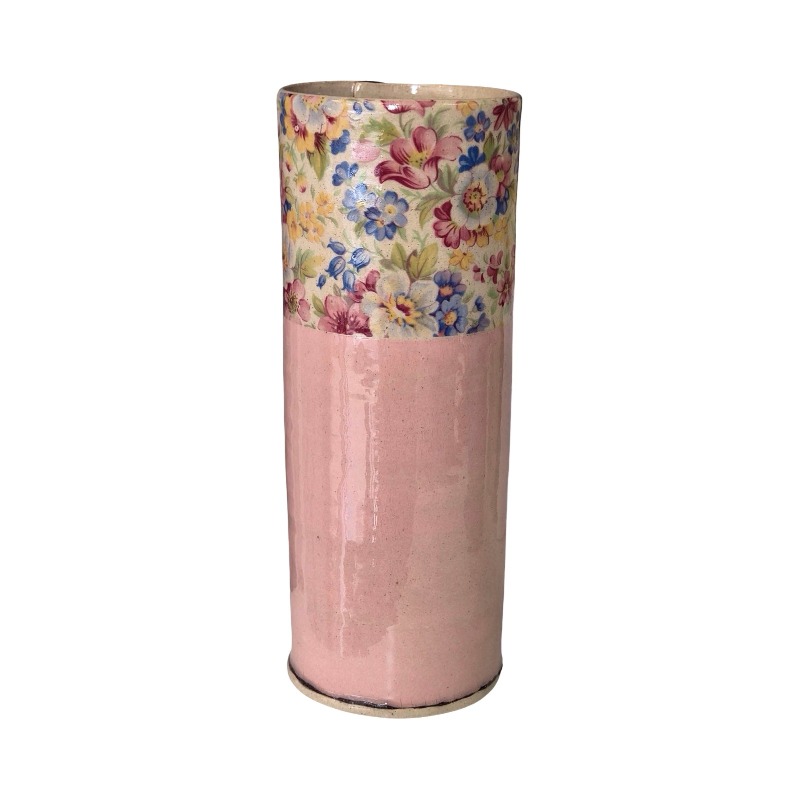 Cylindrical vase with floral patterned top and pink base on a white background.