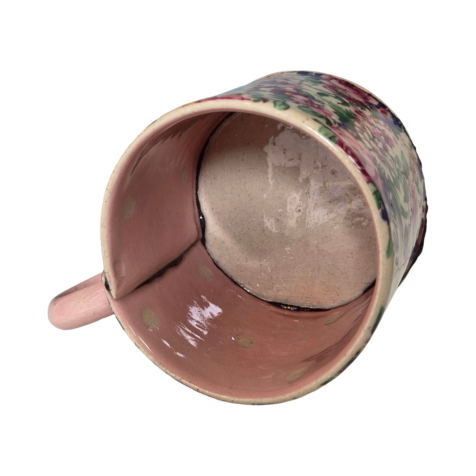 Ceramic mug with floral pattern on a white background.