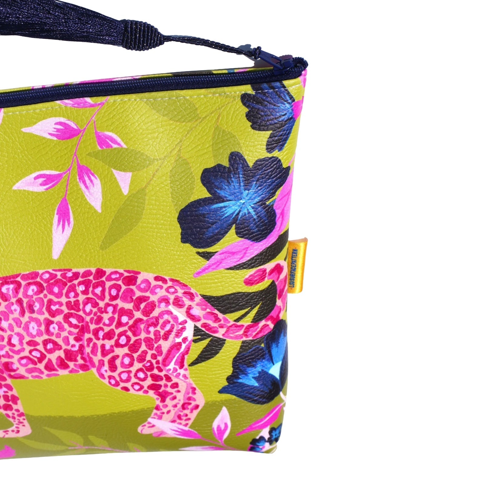 Vegan leather bag with a bright pink leopard surrounded by tropical foliage with a lime green background, and the bag is finished with a fabulous matching tassel on the end of the zip. 