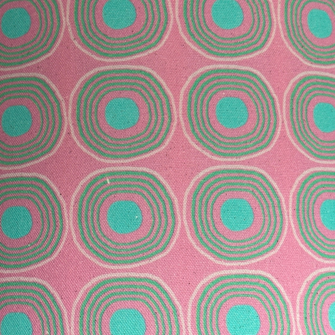 Handmade drum lampshade covered in pink cotton/linen blend fabric with turquoise circles and spots.