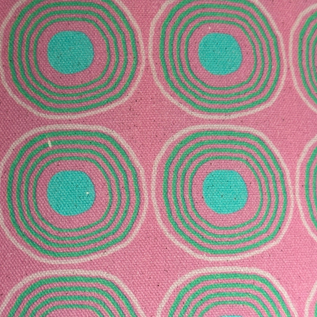 Handmade drum lampshade covered in pink cotton/linen blend fabric with turquoise circles and spots.