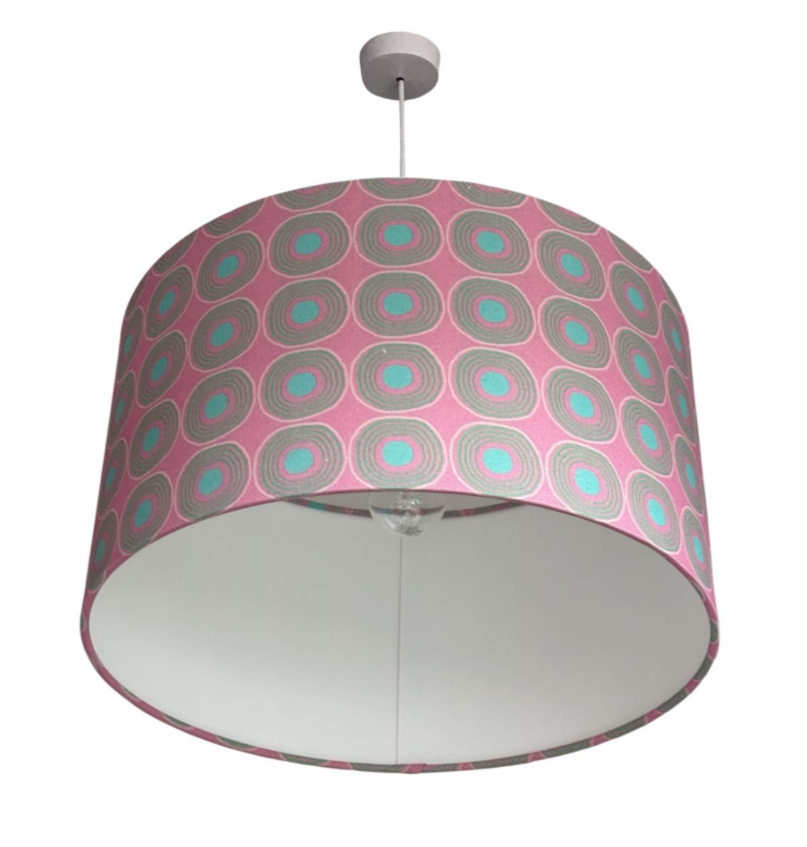 Handmade drum lampshade covered in pink cotton/linen blend fabric with turquoise circles and spots.