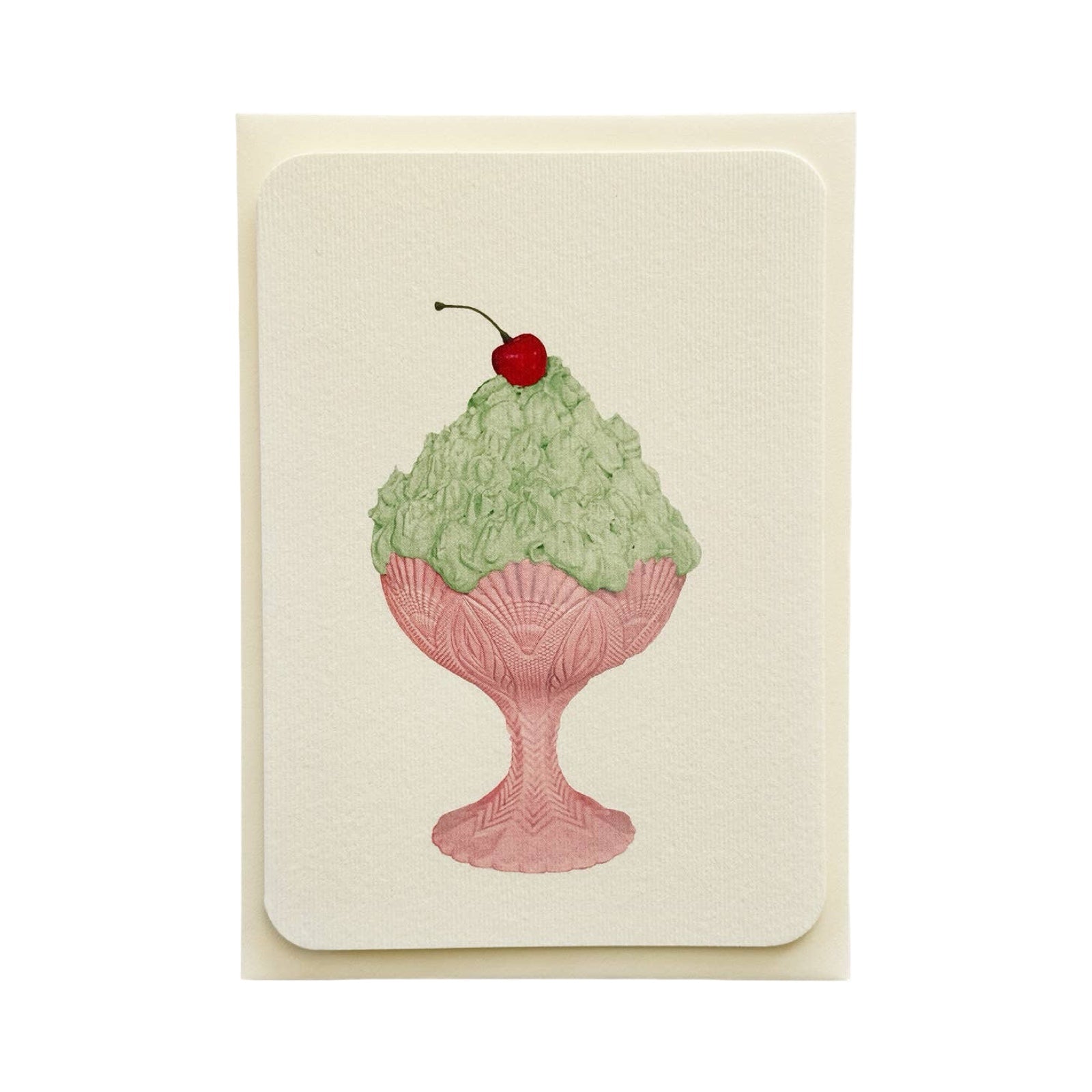 Card with a design of green ice cream in a pink dish with a cherry on top, on a beige background.