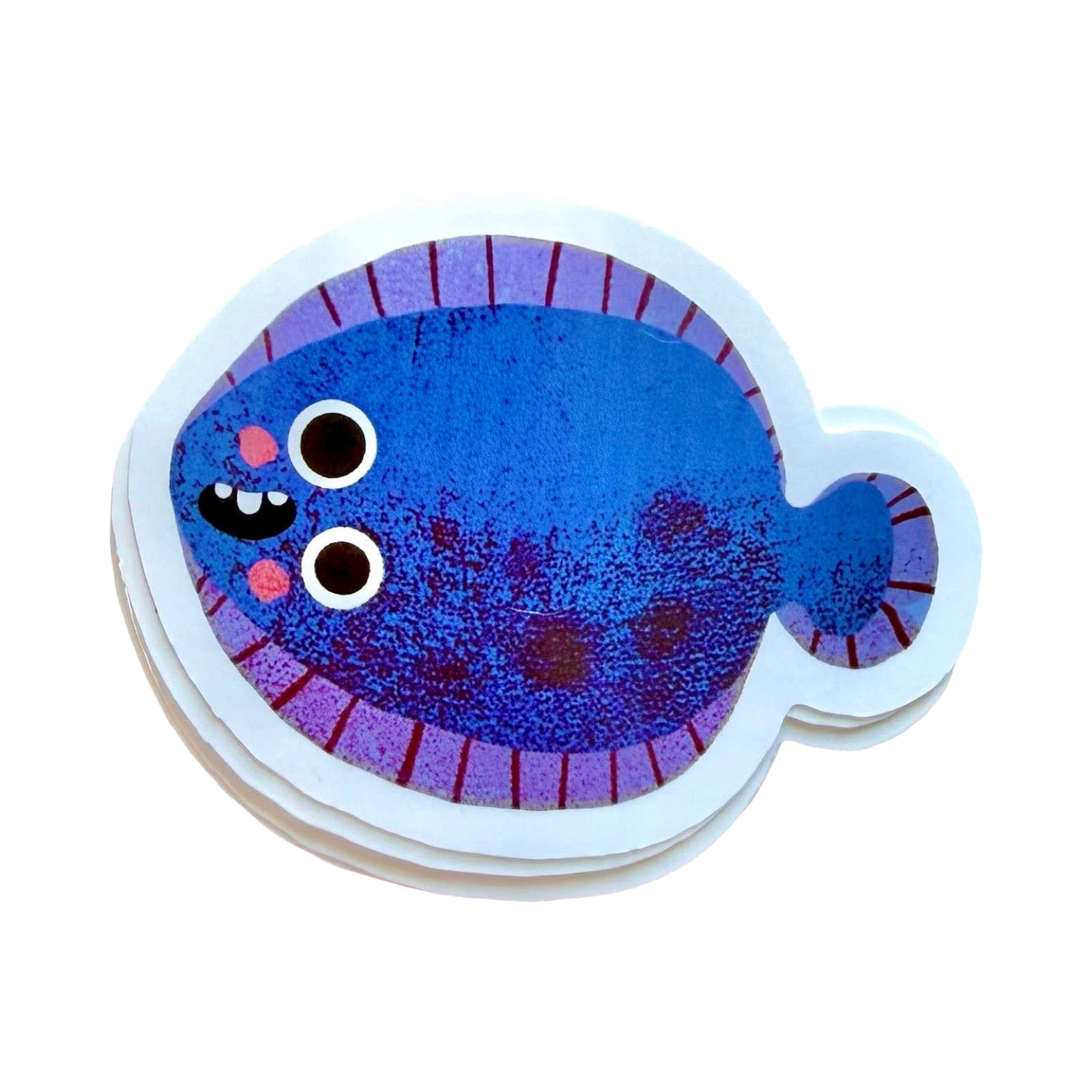A stack of die-cut stickers featuring a cute cartoon flatfish in shades of blue and purple with a white border, shown on a plain white background.