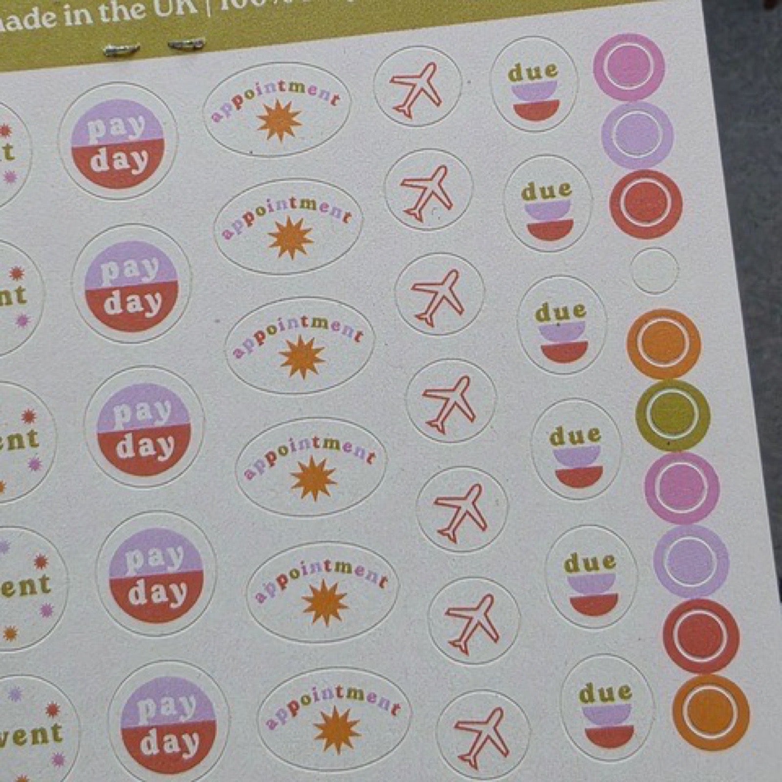 Two sheets of stickers in shades of pink, purple, orange and red  including 'event', 'pay day', 'birthday' and 'remember'.