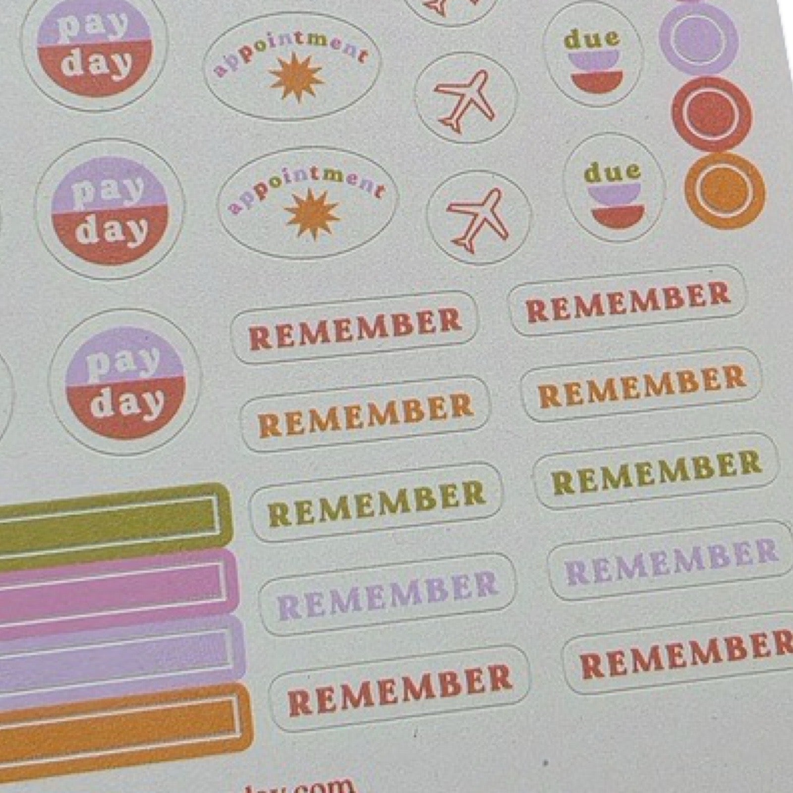 Two sheets of stickers in shades of pink, purple, orange and red  including 'event', 'pay day', 'birthday' and 'remember'.