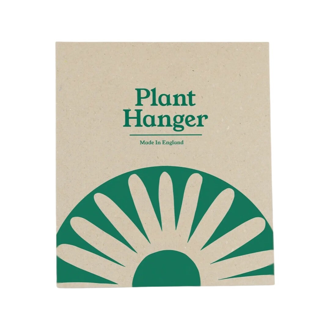 Plant hanger packaging with a green and beige design.