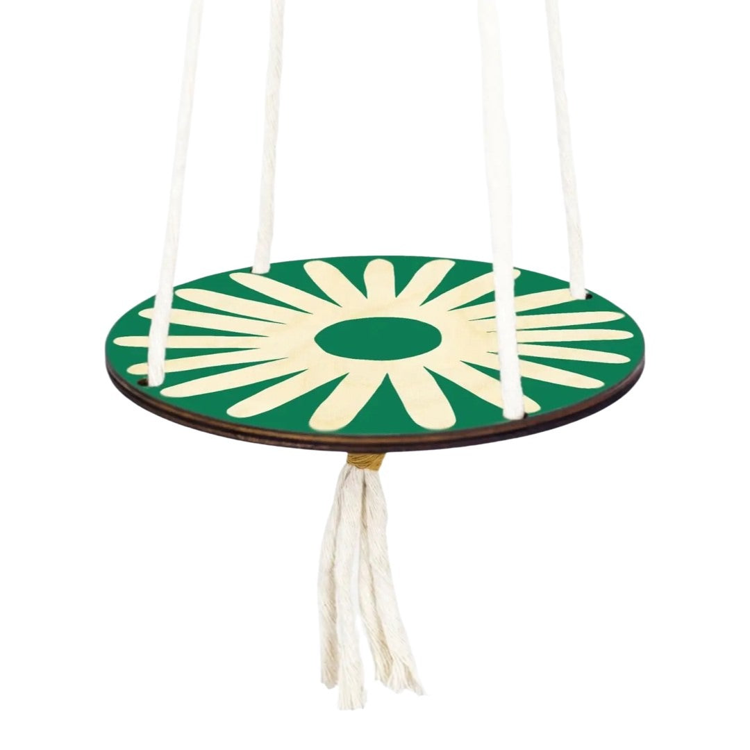 A round green plant hanging platform with a cream daisy design, made of chunky natural white macrame twine with yellow twine knots, and a brass-plated hoop for hanging.