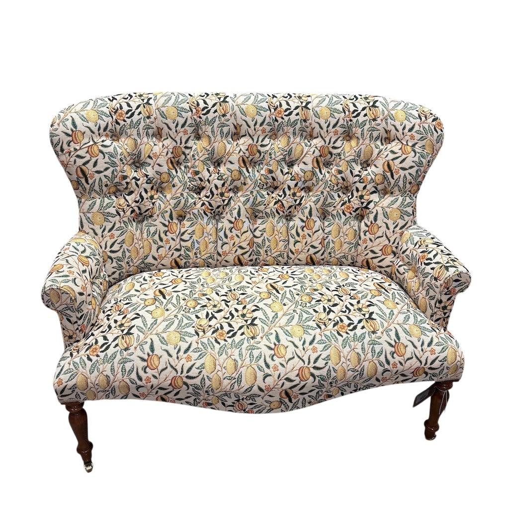 Floral-patterned sofa on a white background.