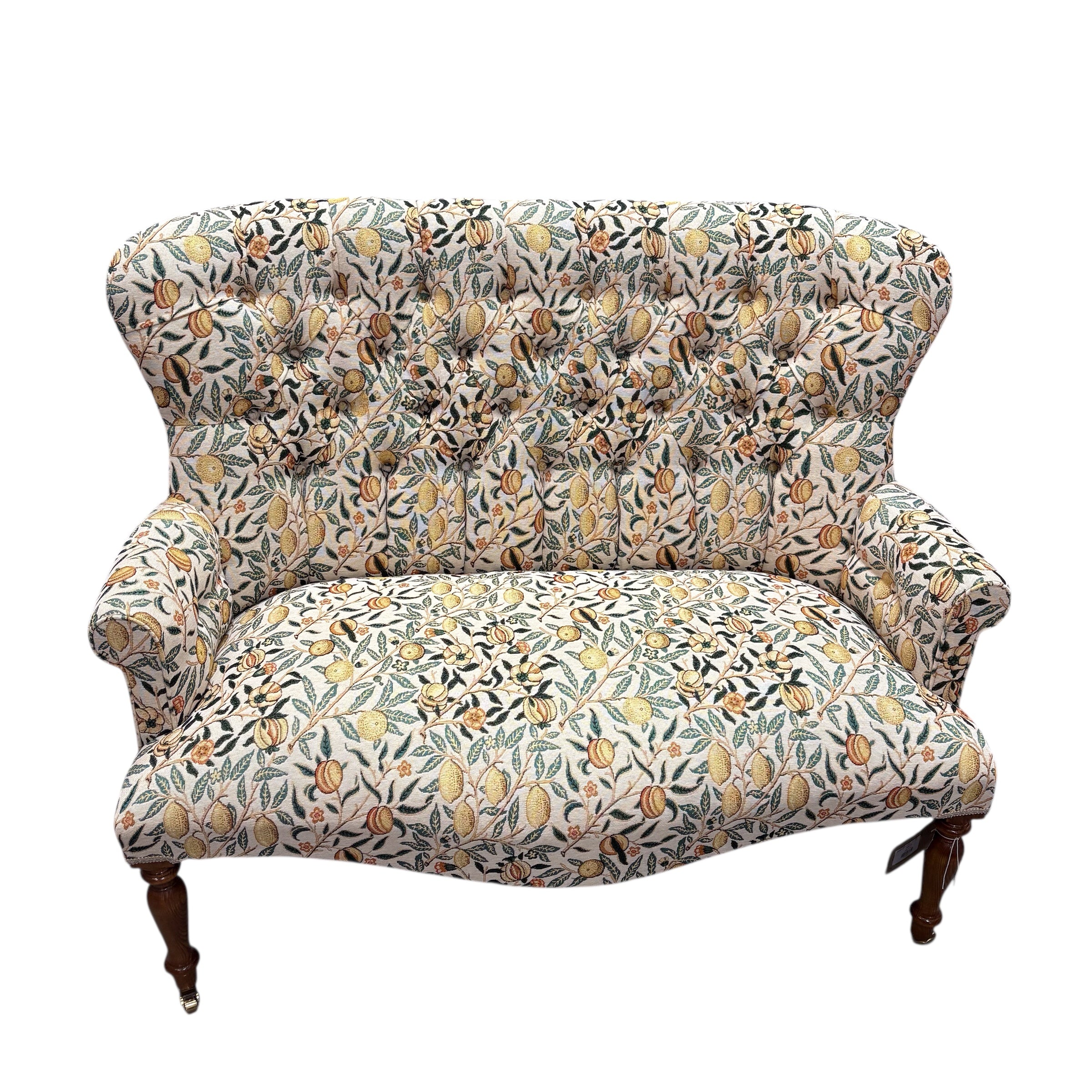 A beautiful hand-crafted occasional two-seater sofa with a high button back covered in gorgeous fabulous&nbsp;woven William Morris style pomegranate fruits fabric in cream with yellow fruit.