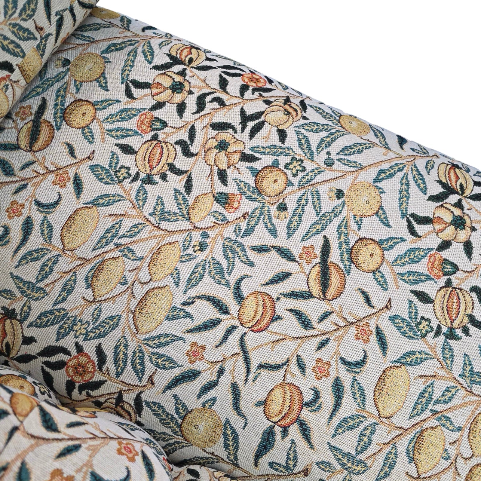 The seat detail of a handcrafted chaise longue in fabulous woven William Morris style pomegranate fruits fabric in cream with yellow fruit.