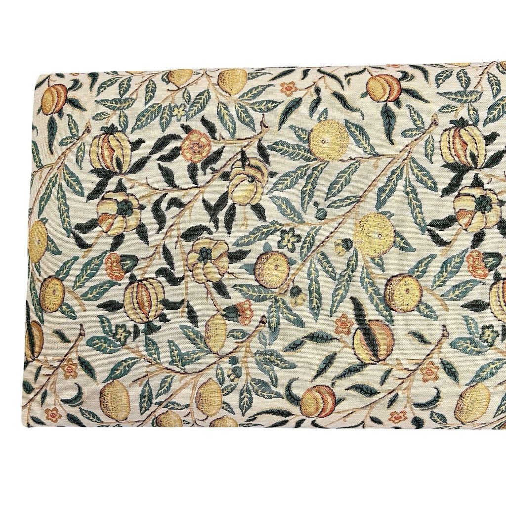 Fabric with a peach and leaf pattern on a white background.
