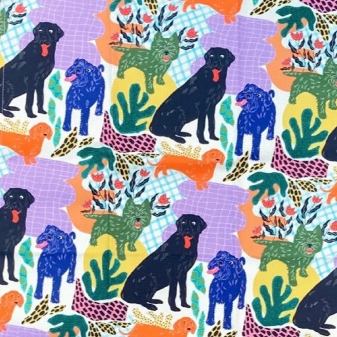 Colourful pattern of dogs and plants on a tea towel.