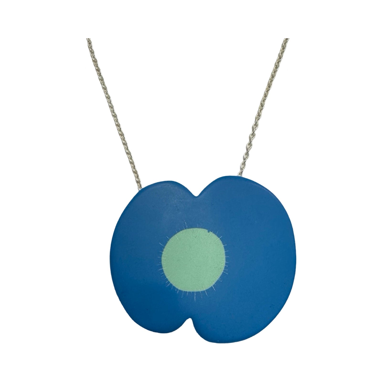 A blue resin poppy-shaped necklace with a pale green centre on a silver chain.