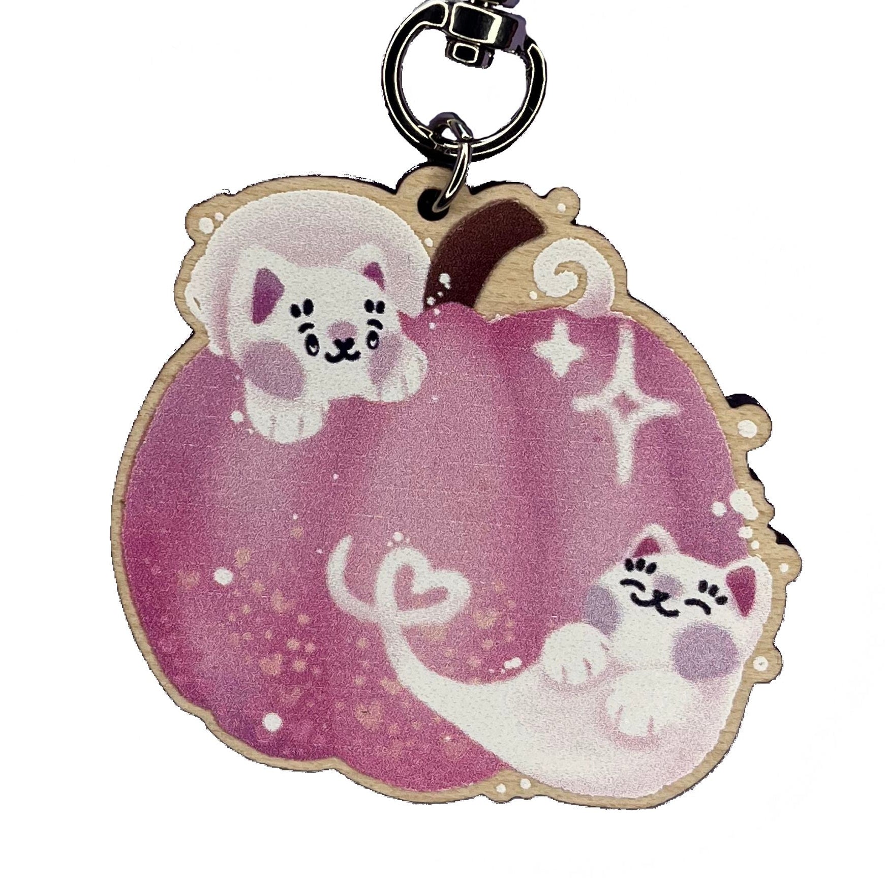 Close up of pink pumpkin wooden keyring design, with two white cat ghosts